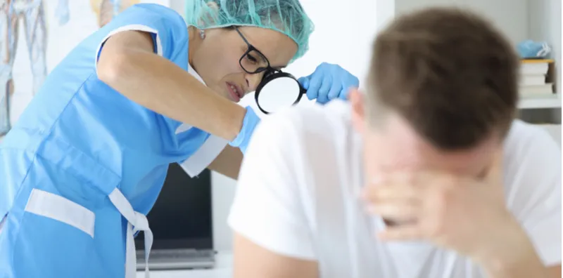 Doctor examining a male patient during a prostate health check